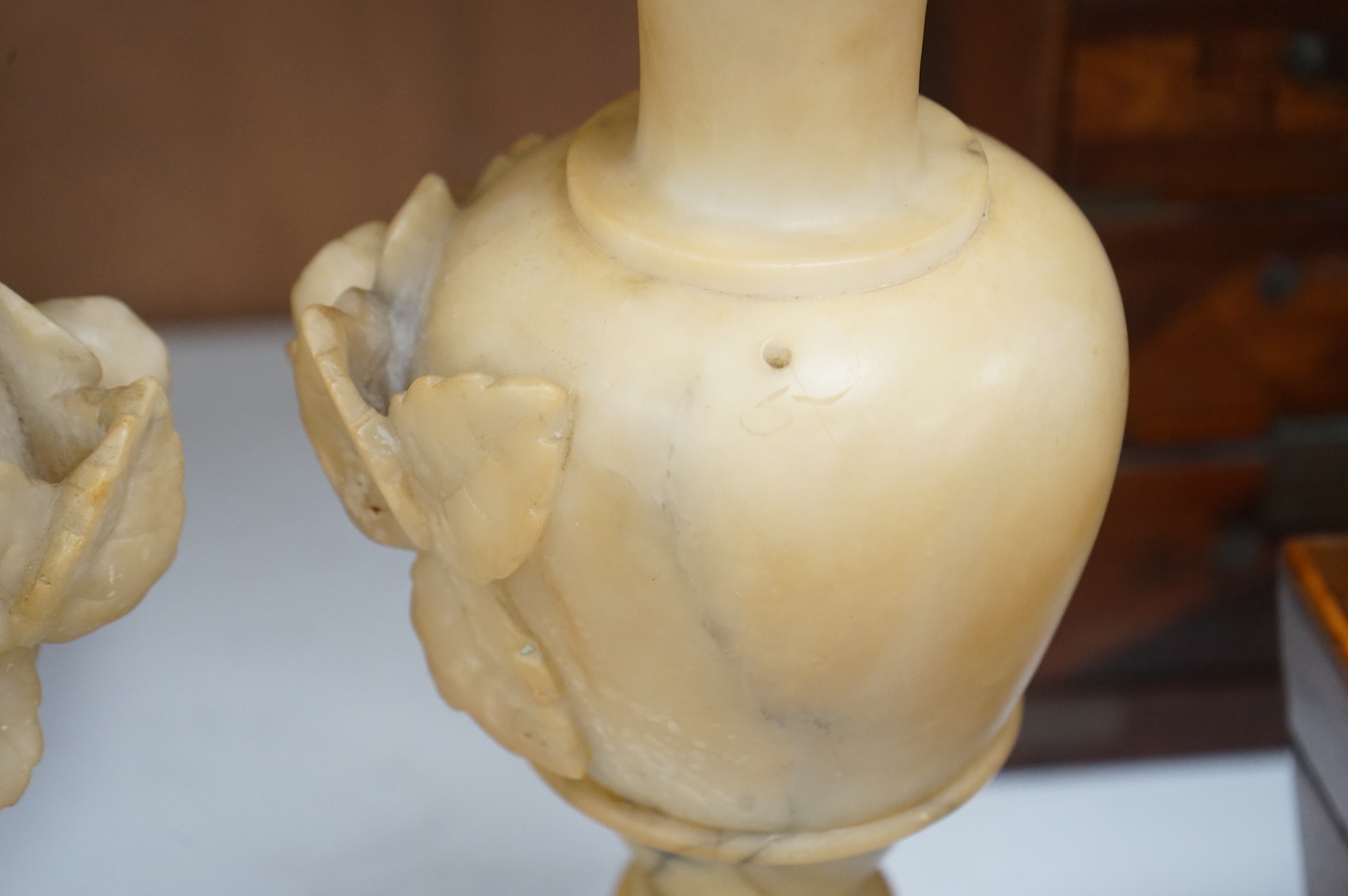 A pair of carved alabaster vases, 32cm high.